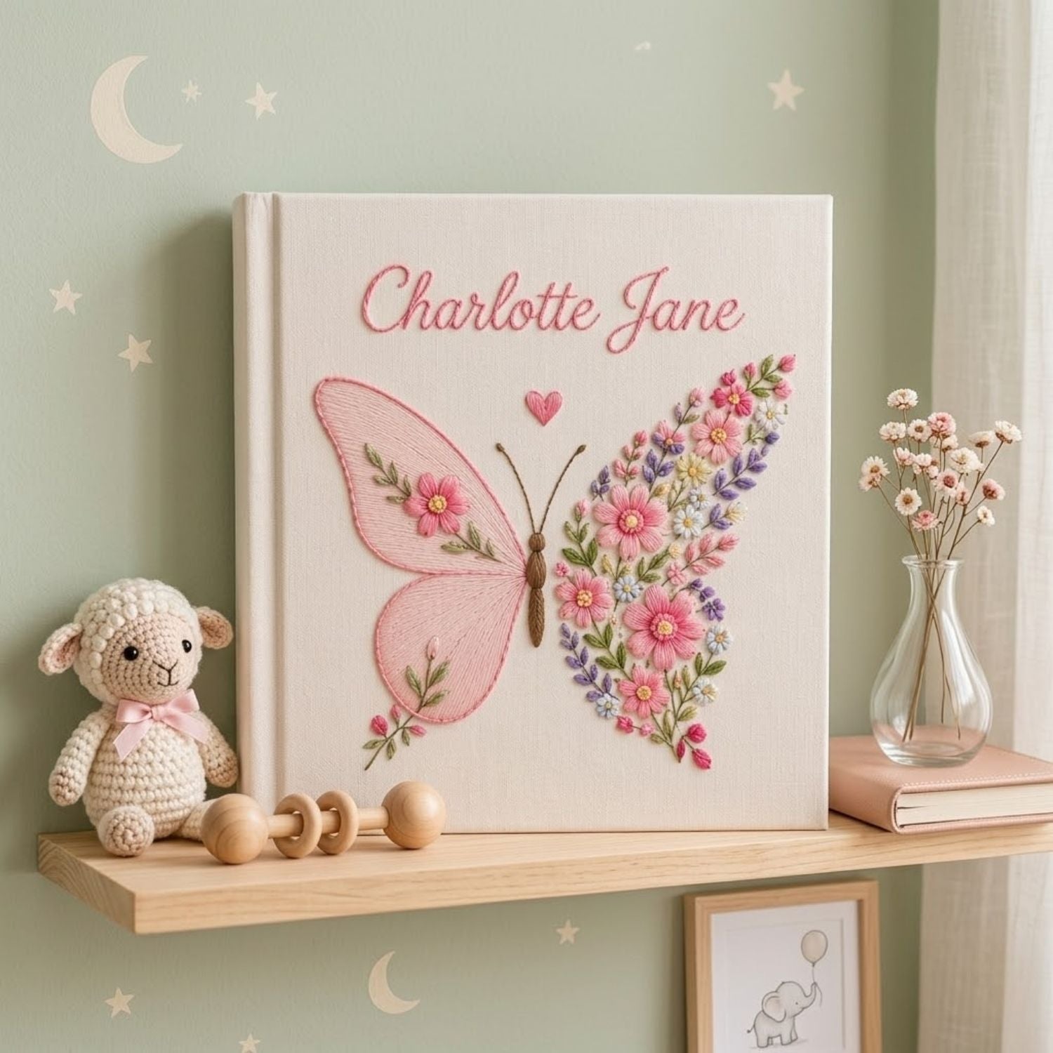 Personalized hand embroidered photo album featuring a floral butterfly with pink wildflowers, lavender accents, and custom name embroidery on a premium linen cover