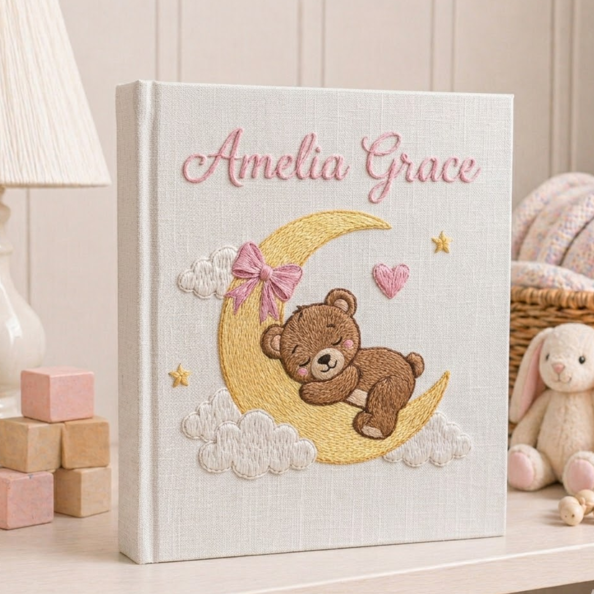 Personalized hand embroidered photo album featuring a sleeping teddy bear resting on a crescent moon with clouds and golden stars