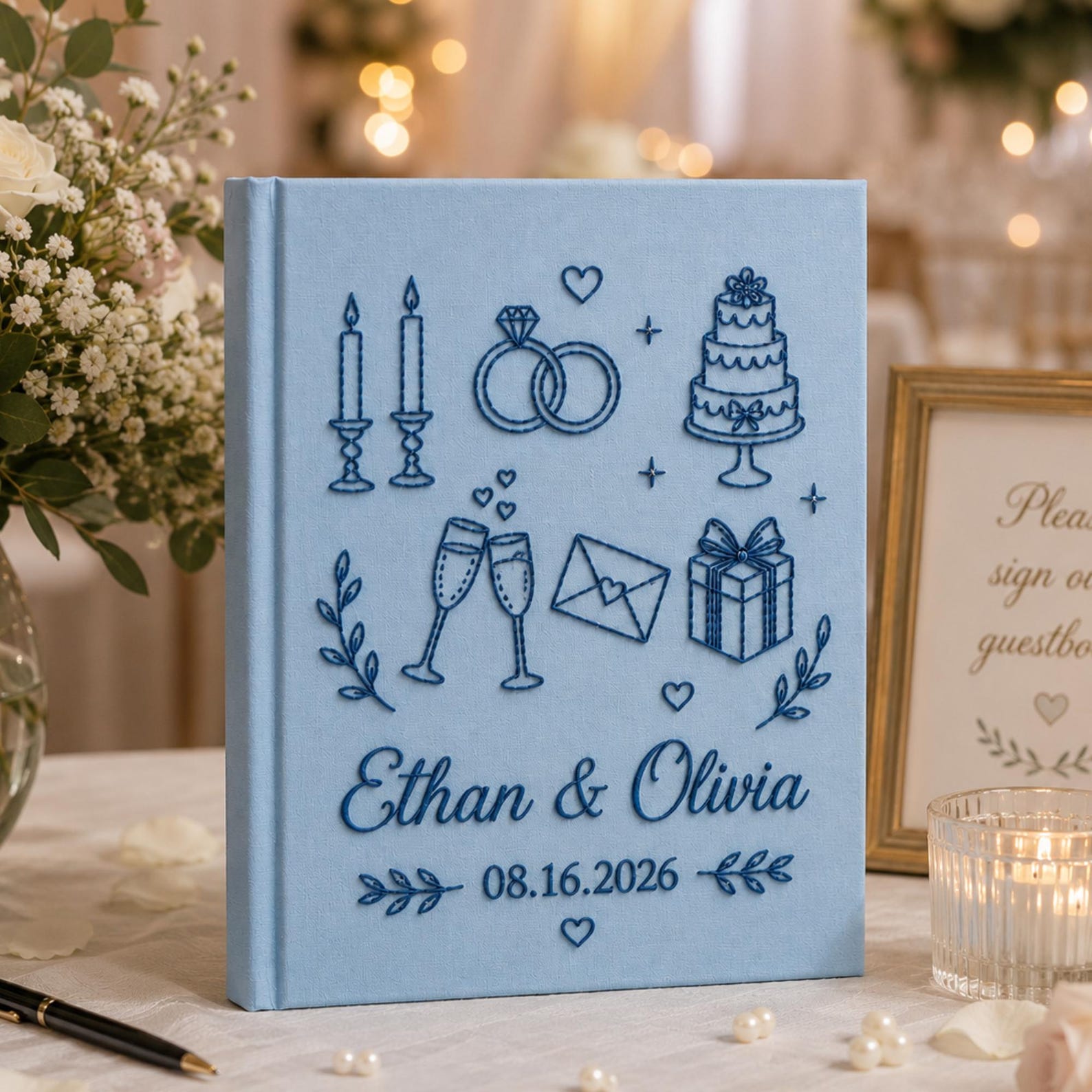 Personalized embroidered wedding photo album with wedding icons rings champagne cake and custom couple names on linen cover