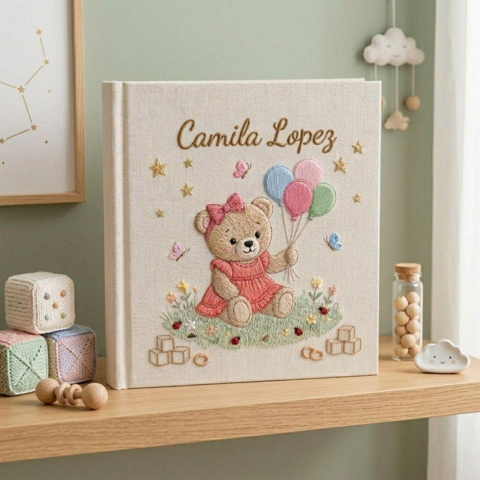 Personalized hand embroidered photo album featuring teddy bear holding pastel balloons surrounded by flowers butterflies and custom baby name