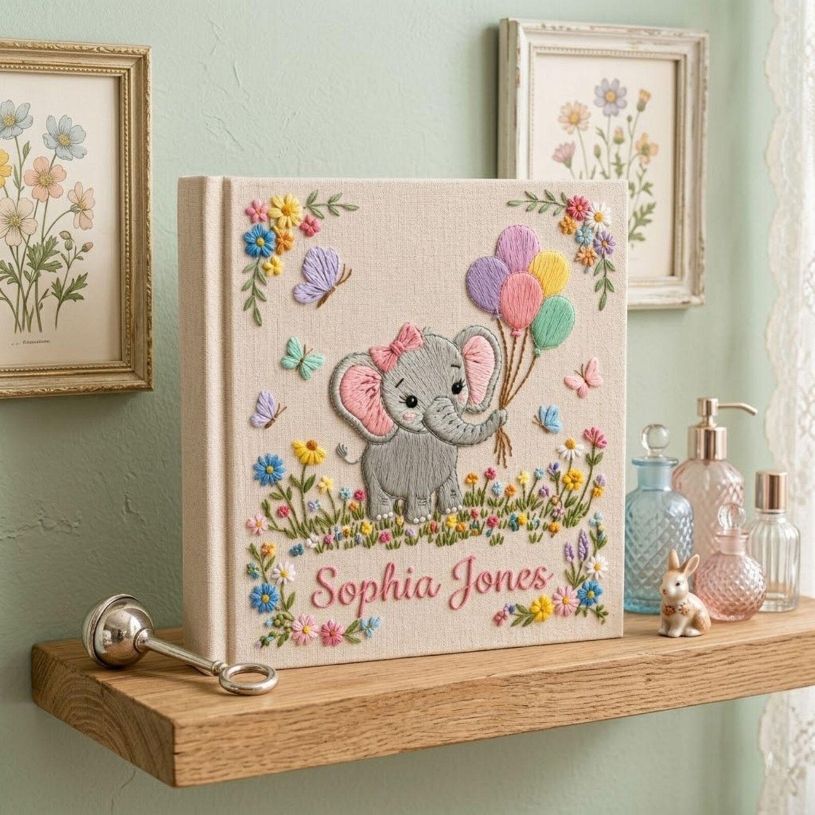Personalized hand embroidered photo album featuring cute elephant holding colorful balloons surrounded by flowers butterflies and custom name embroidery