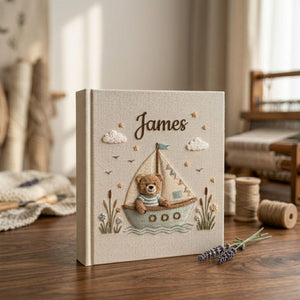 Personalized teddy sailboat hand embroidered baby photo album with nautical coastal nursery design on linen cover