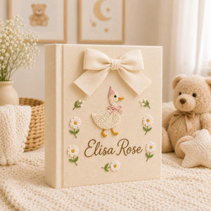 Personalized yellow hand embroidered baby photo album with duckling, daisies, and decorative bow