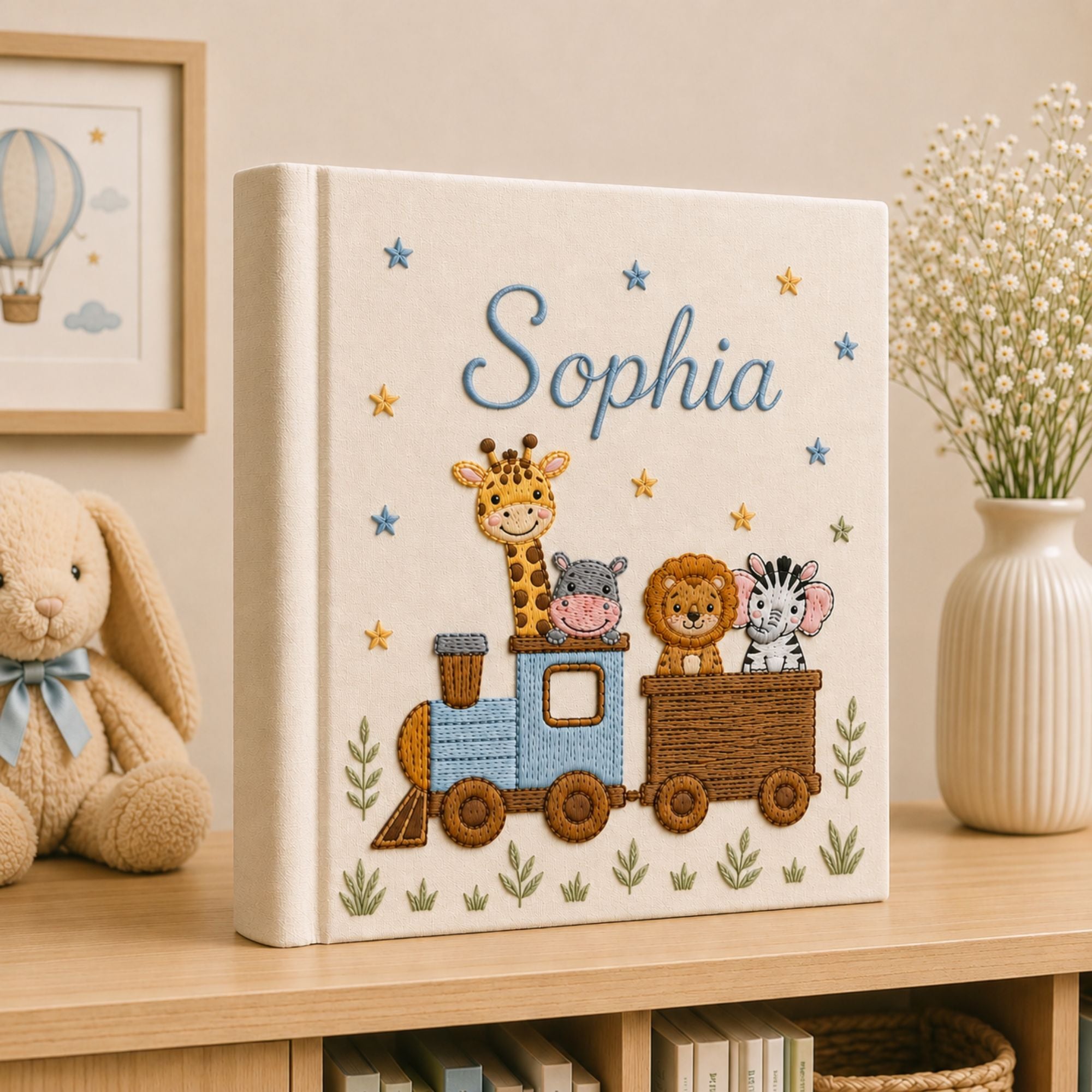 Personalized hand embroidered photo album featuring a safari animal train with giraffe, hippo, lion and zebra on a linen cover