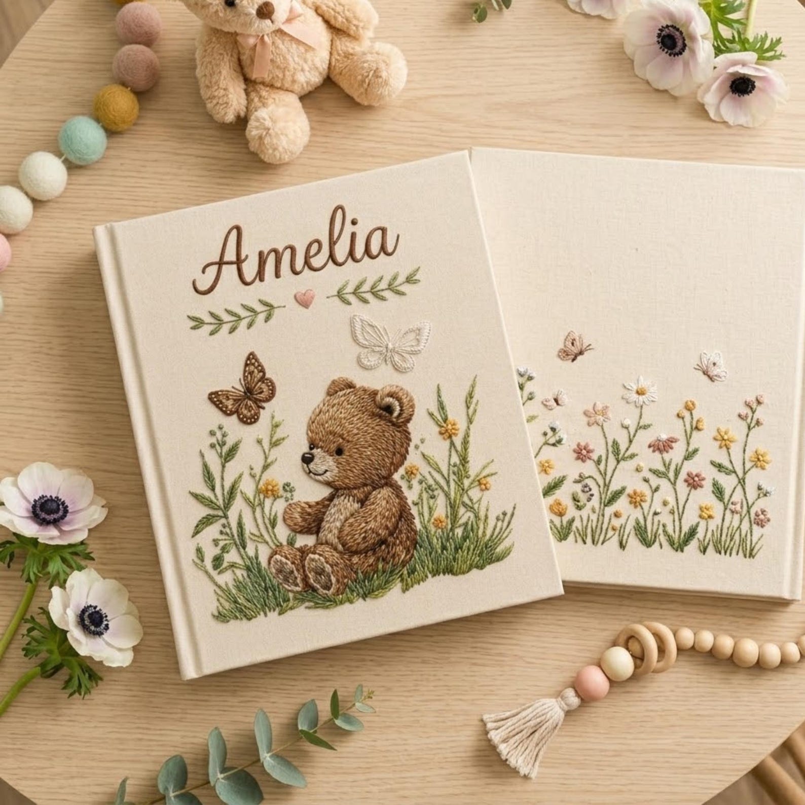 Personalized embroidered baby photo album with woodland teddy bear, butterflies, and greenery design