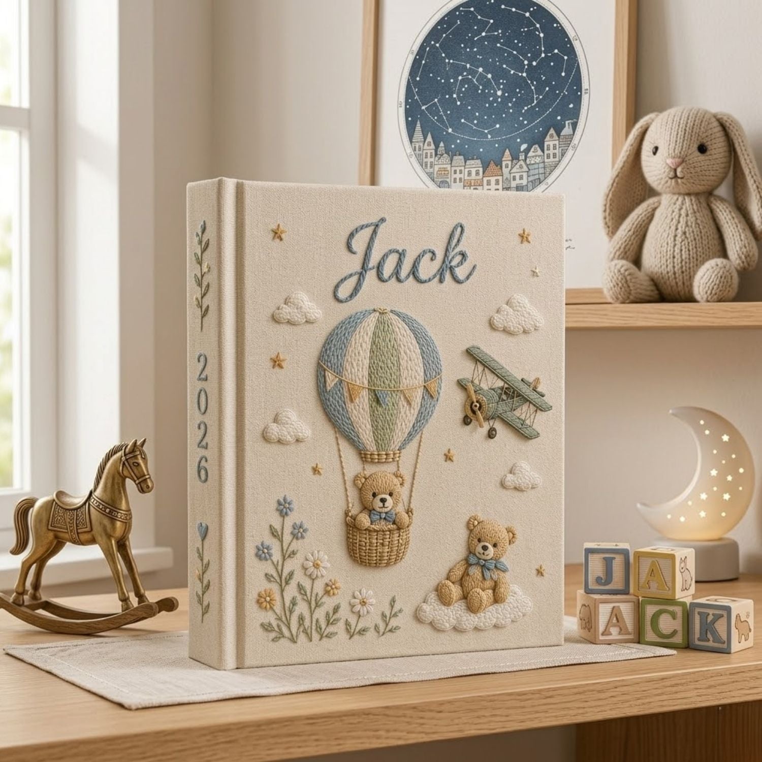 Personalized hand embroidered photo album featuring a teddy bear in a vintage hot air balloon with a classic biplane, clouds, stars, wildflowers, custom name and year embroidery on a premium linen cover