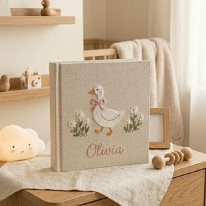 Personalized goose hand embroidered baby photo album with daisy floral cottagecore nursery design on linen cover
