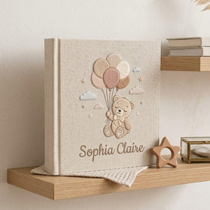 Personalized hand embroidered photo album featuring a teddy bear holding pastel balloons with custom embroidered baby name
