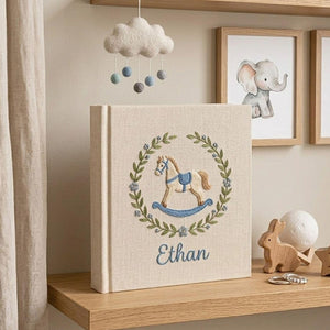 Personalized hand embroidered baby photo album with rocking horse and botanical wreath nursery design
