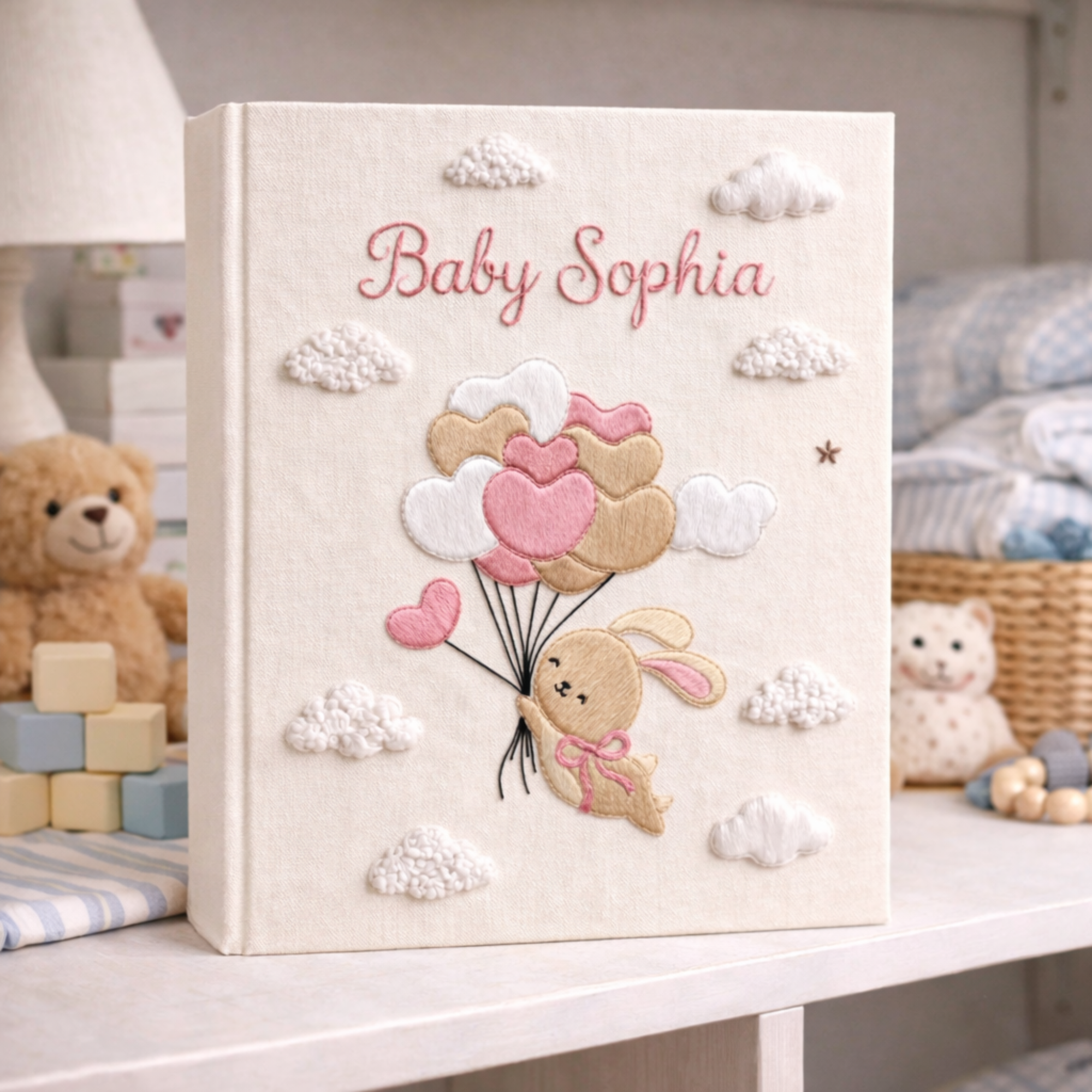 Personalized hand embroidered photo album featuring a bunny holding pastel heart balloons floating among fluffy clouds