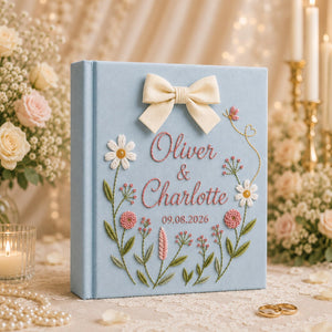 Personalized hand embroidered floral wedding photo album with bow detail and custom couple names on linen cover