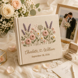 Personalized embroidered wedding photo album with pastel wildflowers, lavender floral embroidery, custom couple names, wedding date, and elegant linen hardcover design