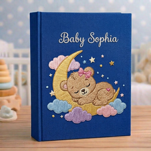 Personalized hand embroidered photo album featuring a dreamland night sky scene with crescent moon, sleeping teddy bear, stars, clouds and custom name embroidery