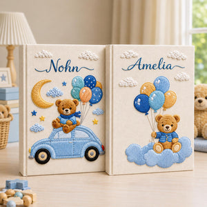 Personalized hand embroidered baby photo album with teddy bear holding blue balloons on clouds