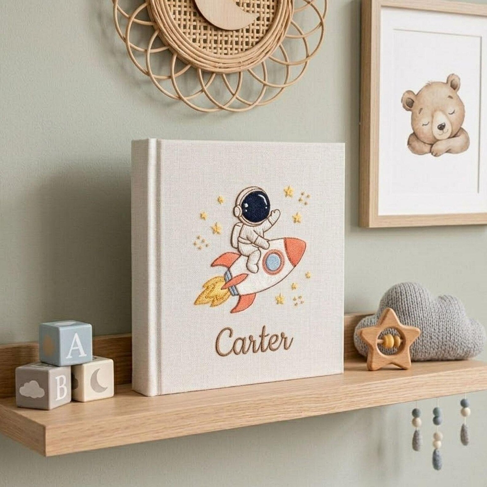 Personalized hand embroidered baby photo album with astronaut riding rocket and stars nursery design