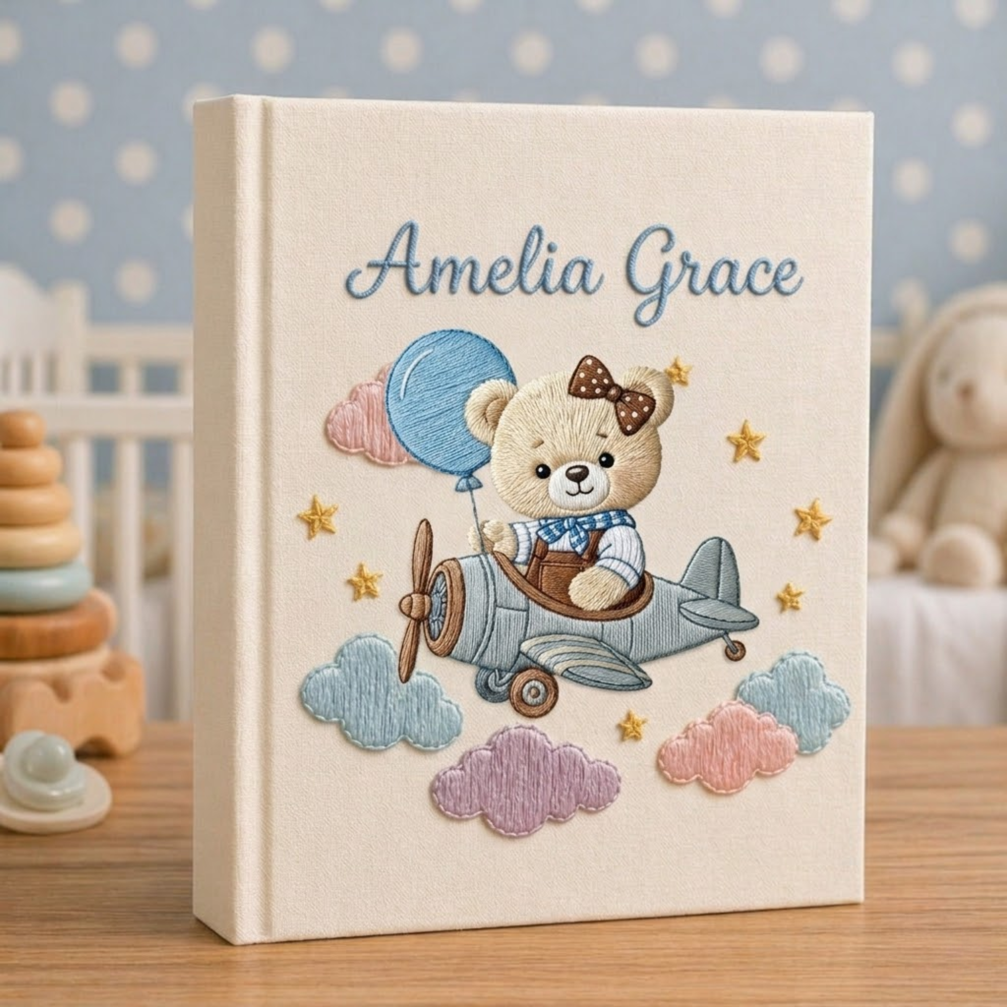 Personalized hand embroidered photo album featuring a vintage aviator teddy bear flying a classic airplane with balloon and banner details