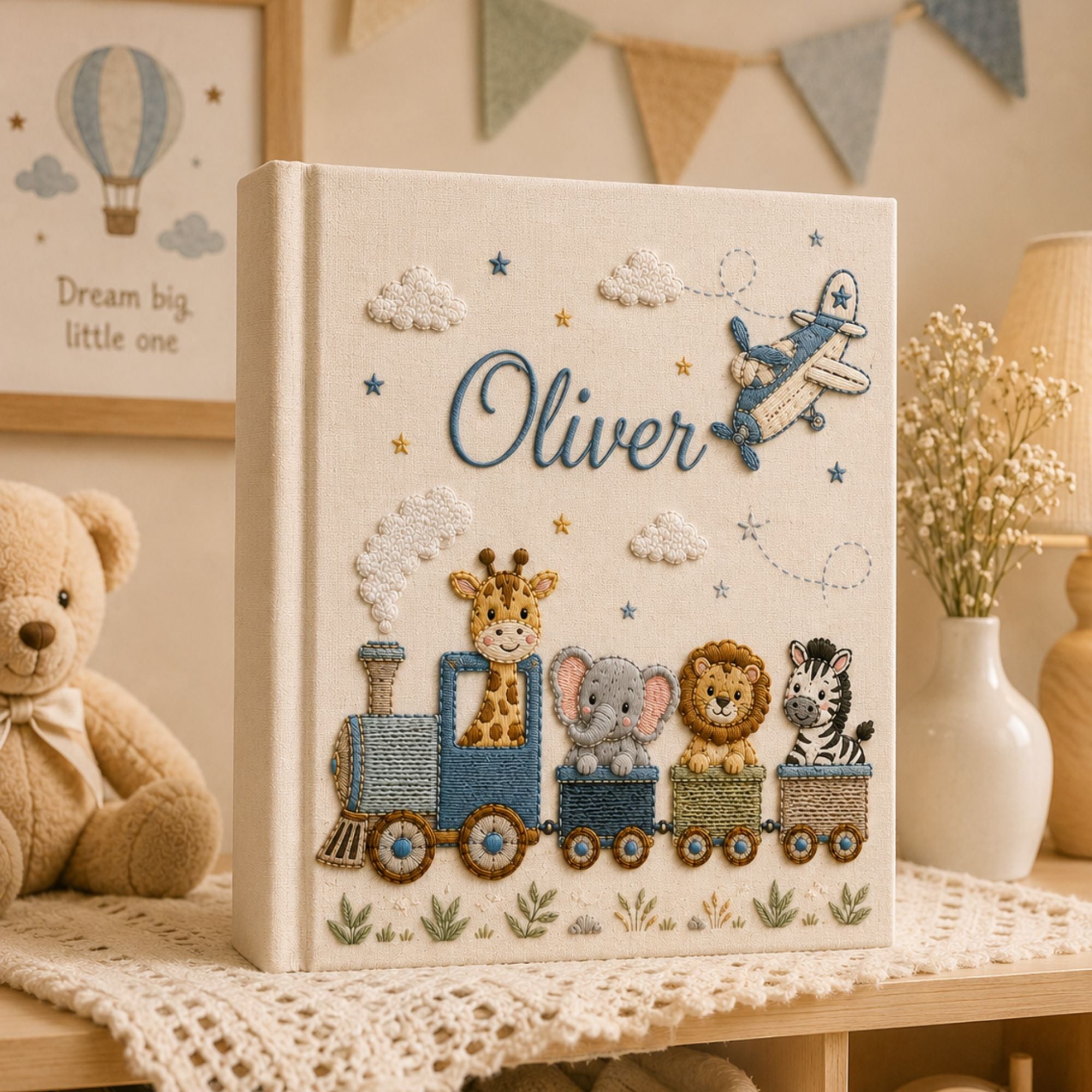 Personalized hand embroidered photo album featuring an adventure train with animal friends, stars, clouds and vintage airplane