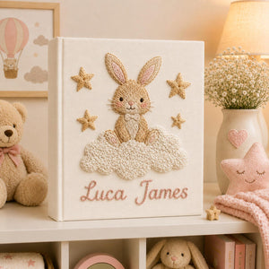 Personalized pink hand embroidered baby photo album with bunny sitting on fluffy clouds and stars