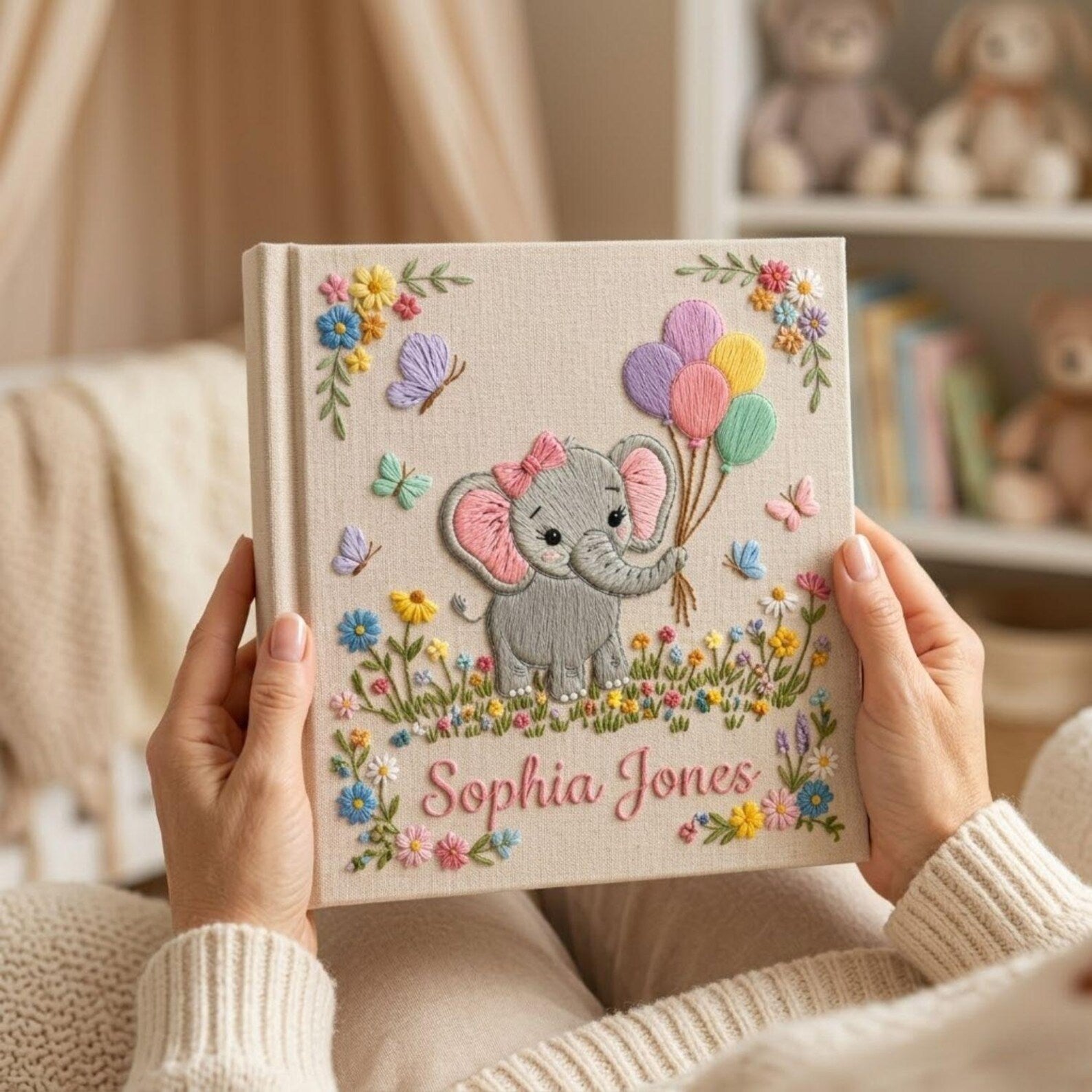 Personalized hand embroidered photo album featuring cute elephant holding colorful balloons surrounded by flowers butterflies and custom name embroidery