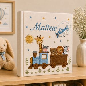 Personalized hand embroidered photo album featuring an adventure train with animal friends, stars, clouds and vintage airplane