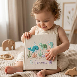 Personalized embroidered baby photo album with whale, turtle, seahorse, crab, ocean plants, and custom name embroidery