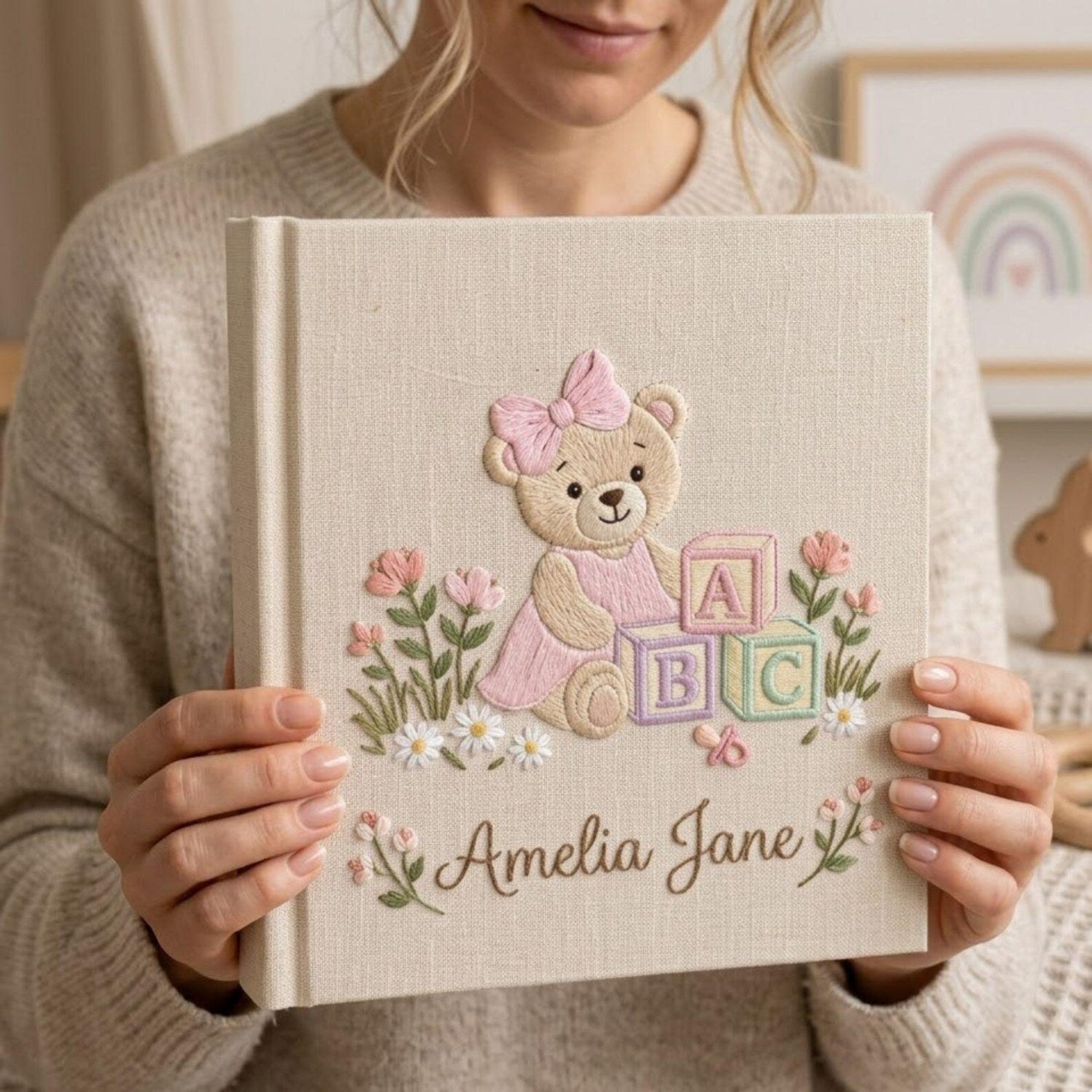 Personalized hand embroidered photo album featuring a teddy bear with pastel ABC blocks floral accents and custom name embroidery