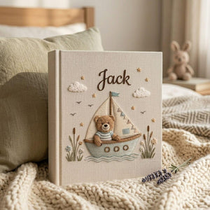 Personalized teddy sailboat hand embroidered baby photo album with nautical coastal nursery design on linen cover