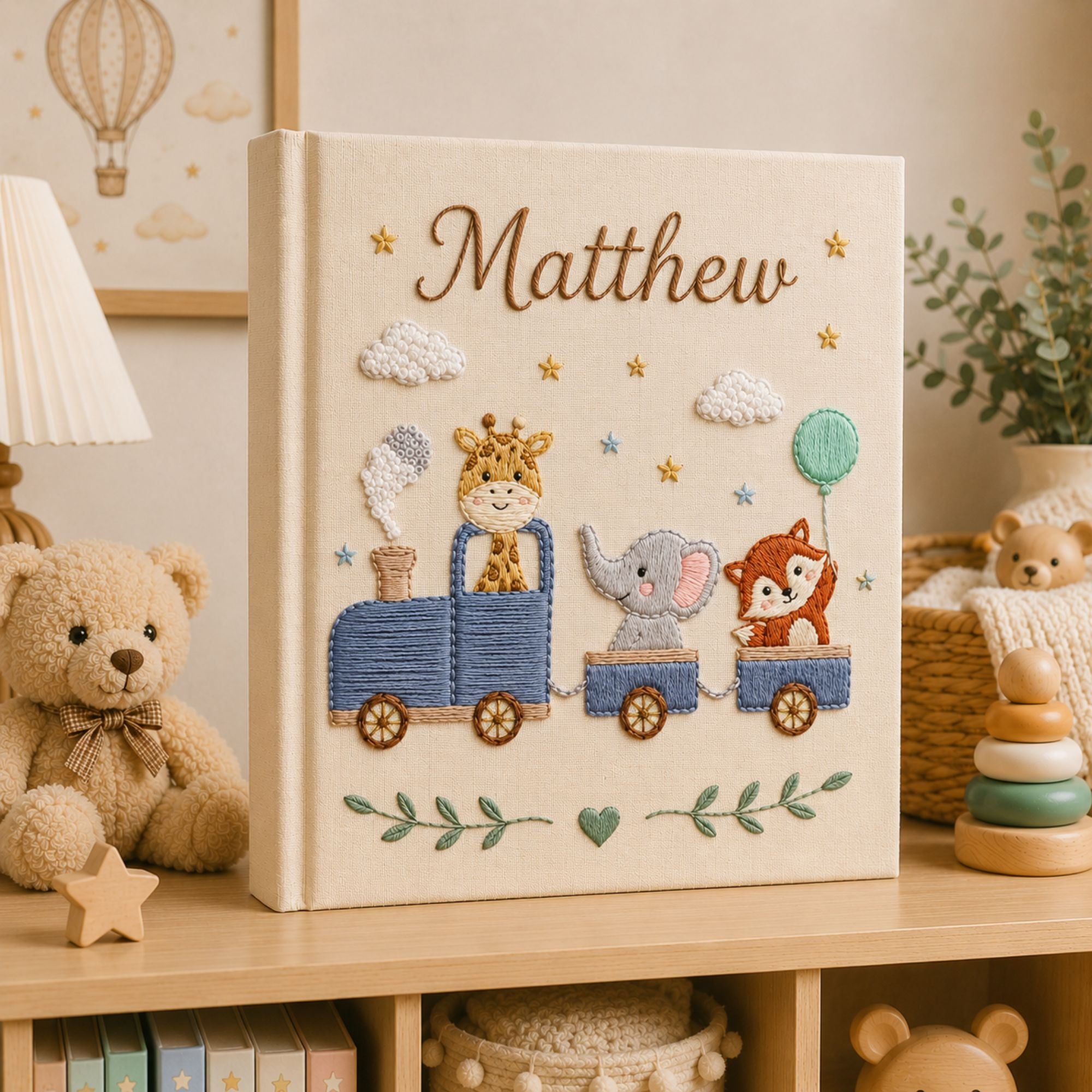 Personalized hand embroidered photo album featuring a safari animal train with giraffe, hippo, lion and zebra on a linen cover