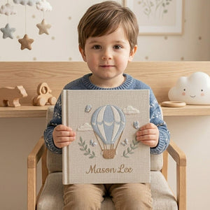 Personalized hand embroidered photo album featuring a blue hot air balloon with butterflies clouds and custom baby name