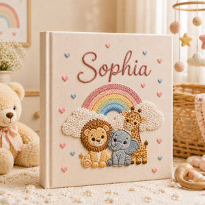 Personalized hand embroidered photo album featuring lion elephant and giraffe under a pastel rainbow with custom name embroidery