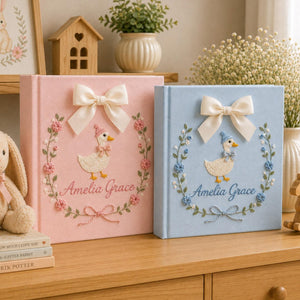Personalized pink hand embroidered baby photo album with duckling, floral wreath, and ribbon bow