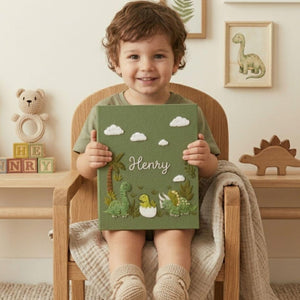 Personalized dinosaur hand embroidered baby photo album with cute prehistoric nursery design on green linen cover