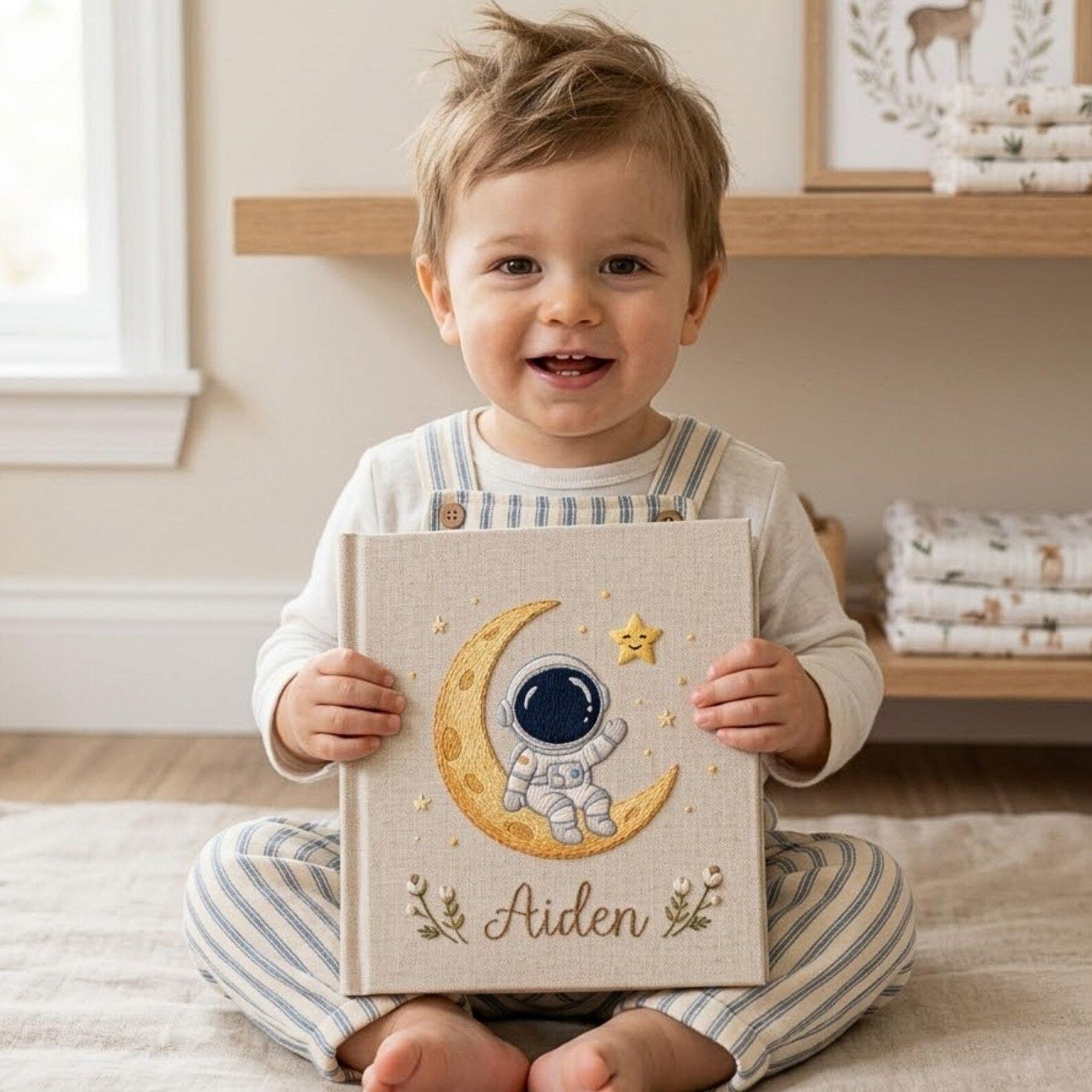 Personalized hand embroidered baby photo album with astronaut sitting on crescent moon and stars nursery design