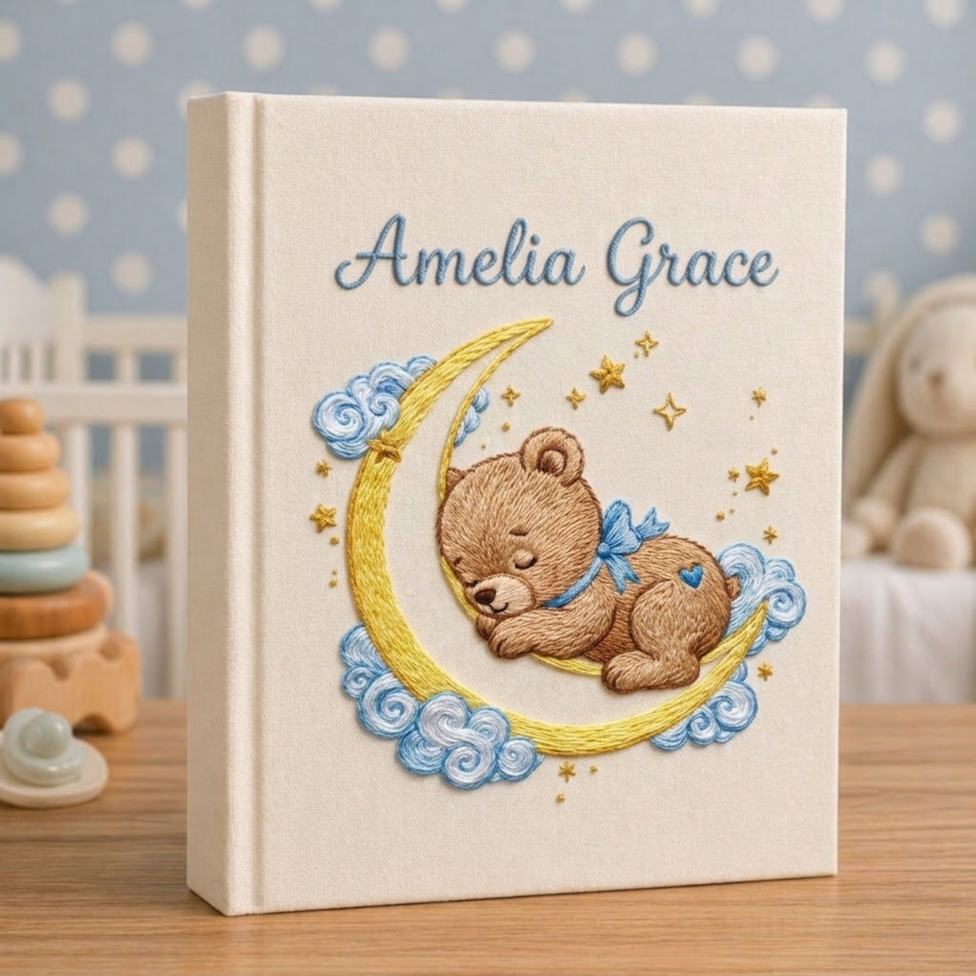Personalized hand embroidered photo album featuring a sleeping teddy bear resting on a crescent moon with clouds and golden stars