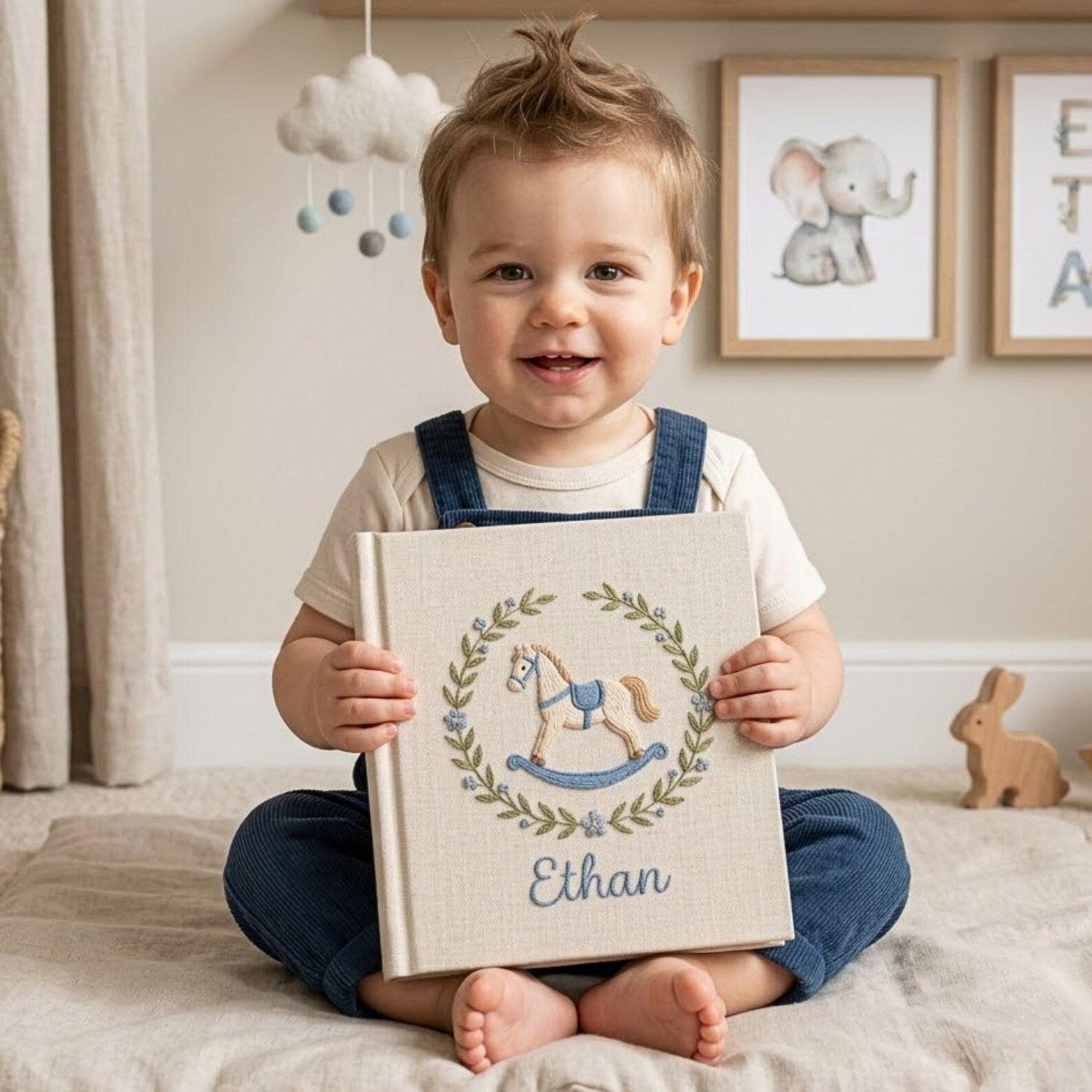 Personalized hand embroidered baby photo album with rocking horse and botanical wreath nursery design