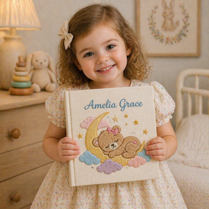 Personalized hand embroidered photo album featuring a dreamland night sky scene with crescent moon, sleeping teddy bear, stars, clouds and custom name embroidery