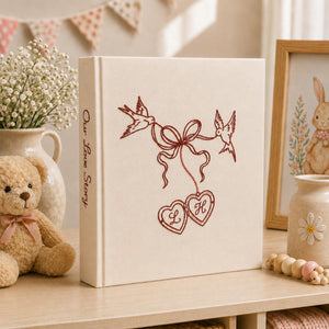 Personalized embroidered wedding photo album with minimalist birds ribbon hearts and custom initials on linen cover