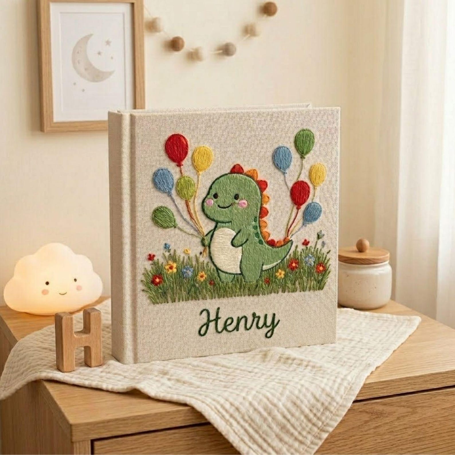 Personalized dinosaur hand embroidered baby photo album with colorful balloons and custom name on linen cover