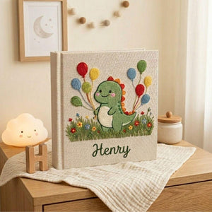 Personalized dinosaur hand embroidered baby photo album with colorful balloons and custom name on linen cover