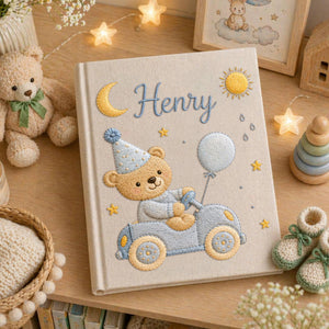 Personalized hand embroidered baby photo album featuring teddy bear driving a pastel blue vintage car with balloon, moon, stars, and sunshine accents