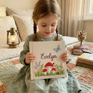 Personalized woodland mushroom embroidered baby photo album with whimsical forest design on linen cover