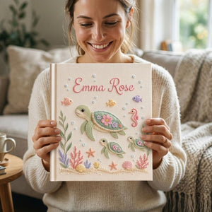 Personalized hand embroidered photo album featuring a sea turtle family with coral reefs, tropical fish, seashells, starfish, and seahorse on a premium linen cover customized with a baby name