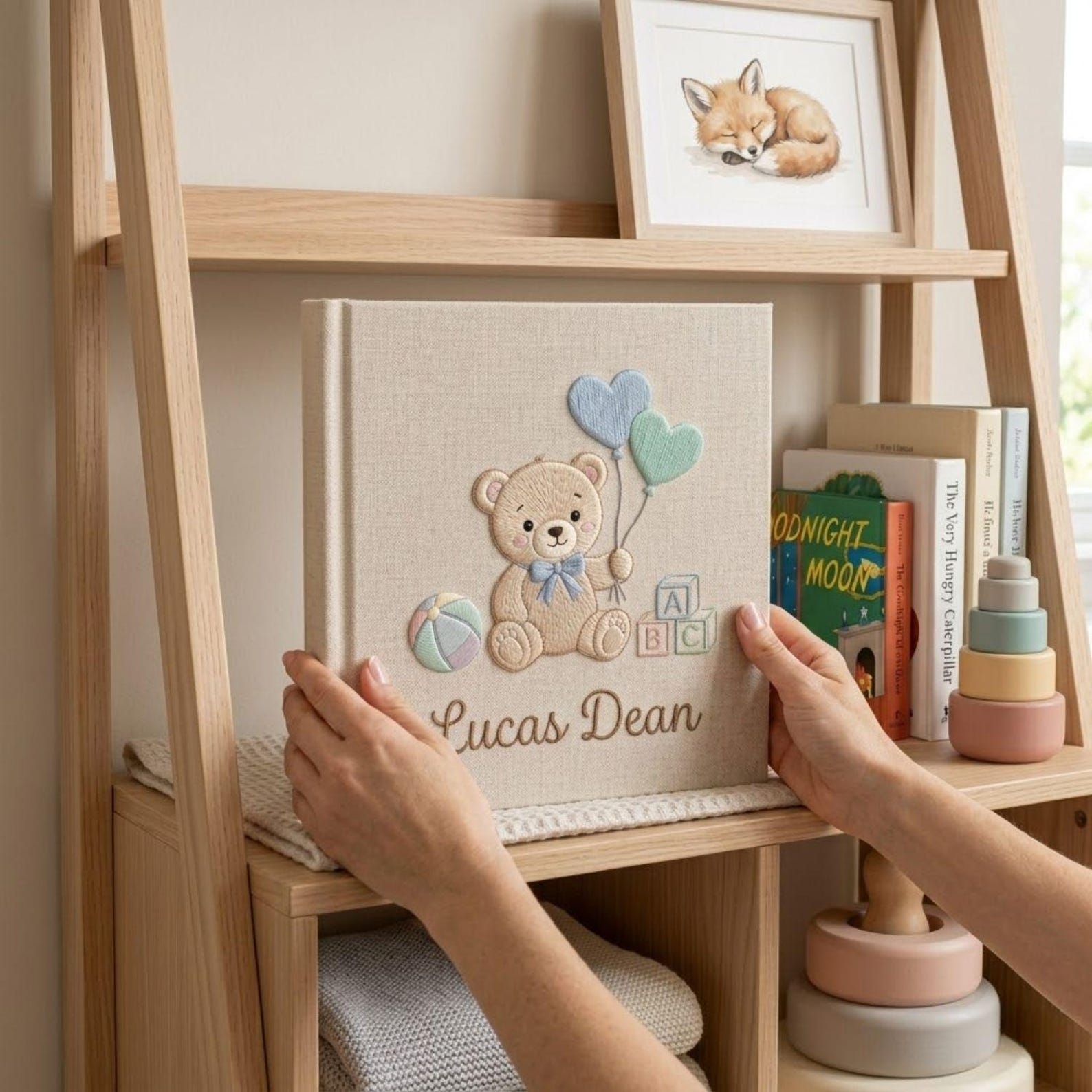 Personalized hand embroidered photo album featuring a teddy bear holding heart-shaped balloons with alphabet blocks and custom baby name