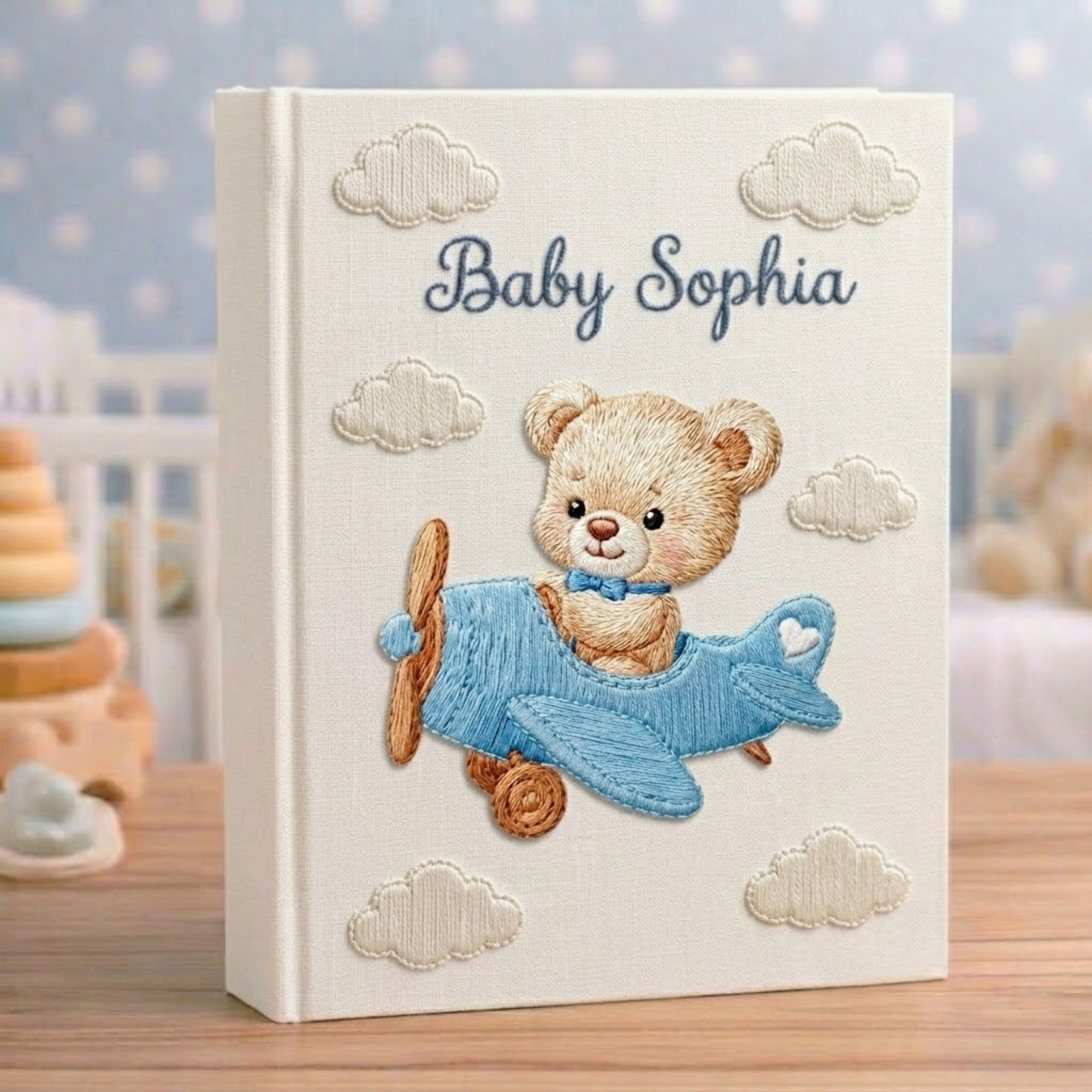 Personalized hand embroidered photo album featuring a vintage aviator teddy bear flying a classic airplane with balloon and banner details