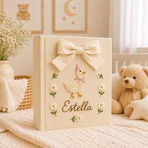Personalized yellow hand embroidered baby photo album with duckling, daisies, and decorative bow