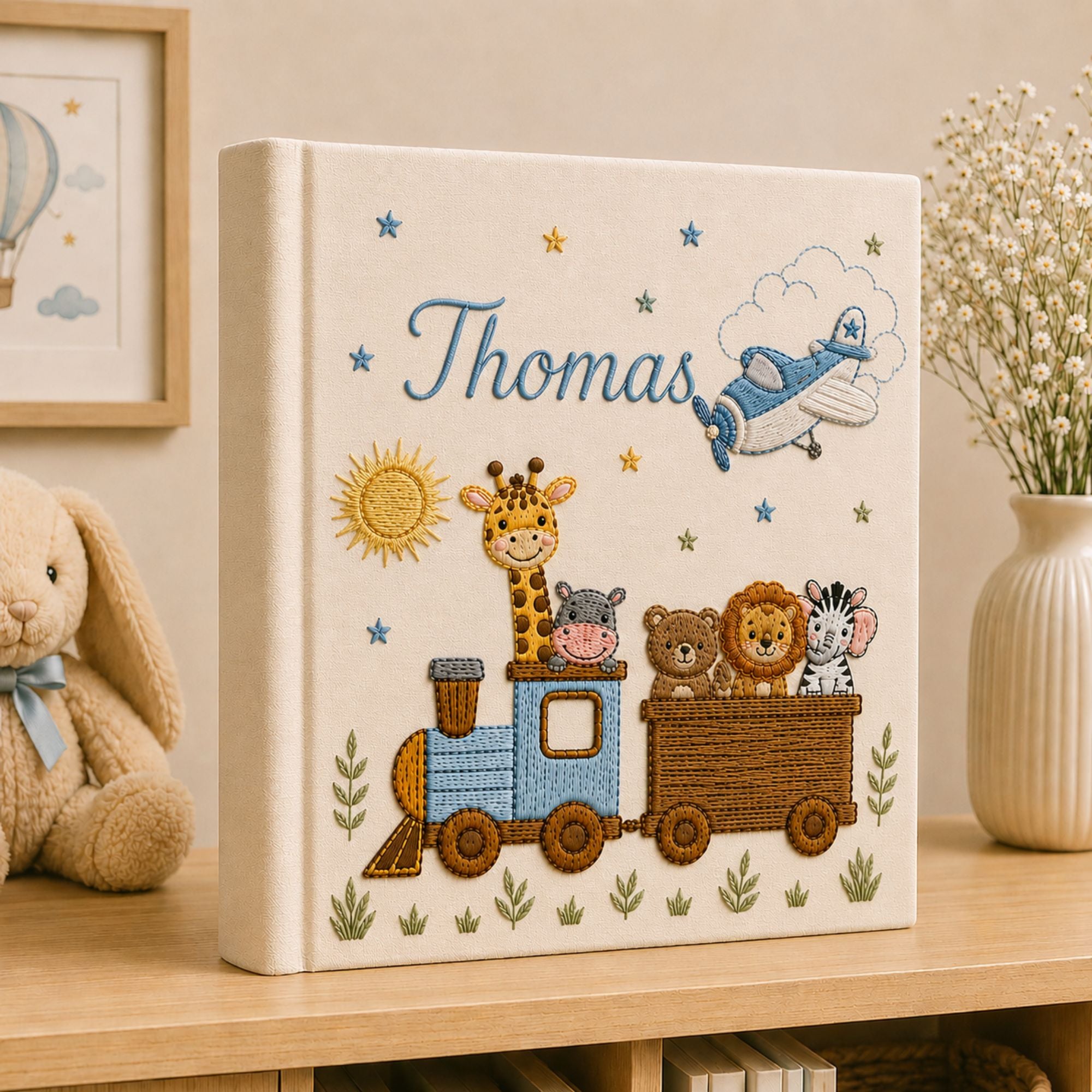 Personalized hand embroidered photo album featuring an adventure train with animal friends, stars, clouds and vintage airplane