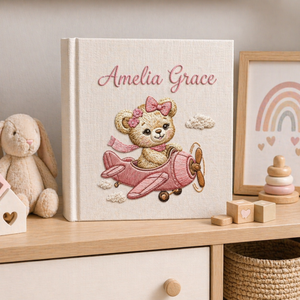 Personalized hand embroidered photo album featuring a vintage aviator teddy bear flying a classic airplane with balloon and banner details