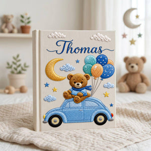 Personalized hand embroidered baby photo album featuring teddy bear on vintage blue car with balloons, moon, stars, and custom name embroidery
