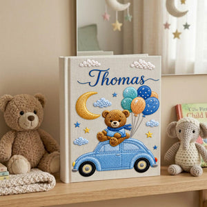 Personalized hand embroidered baby photo album featuring teddy bear on vintage blue car with balloons, moon, stars, and custom name embroidery