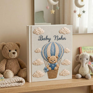 Personalized embroidered baby photo album with teddy bear in blue sky balloon basket and fluffy cloud embroidery